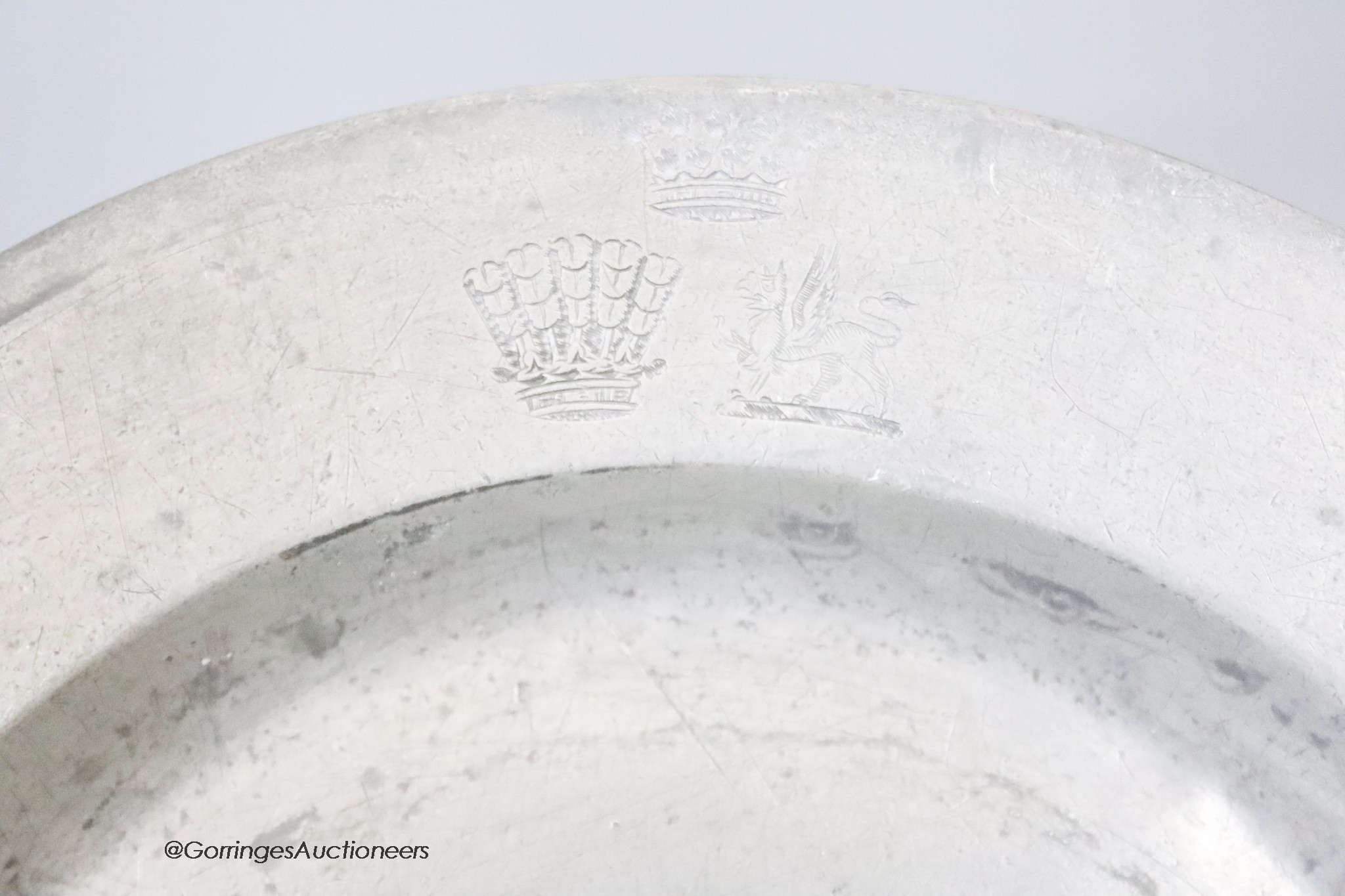 A set of eighteen 19th century pewter plates engraved with the Wentworth family crest, diameter 25cm